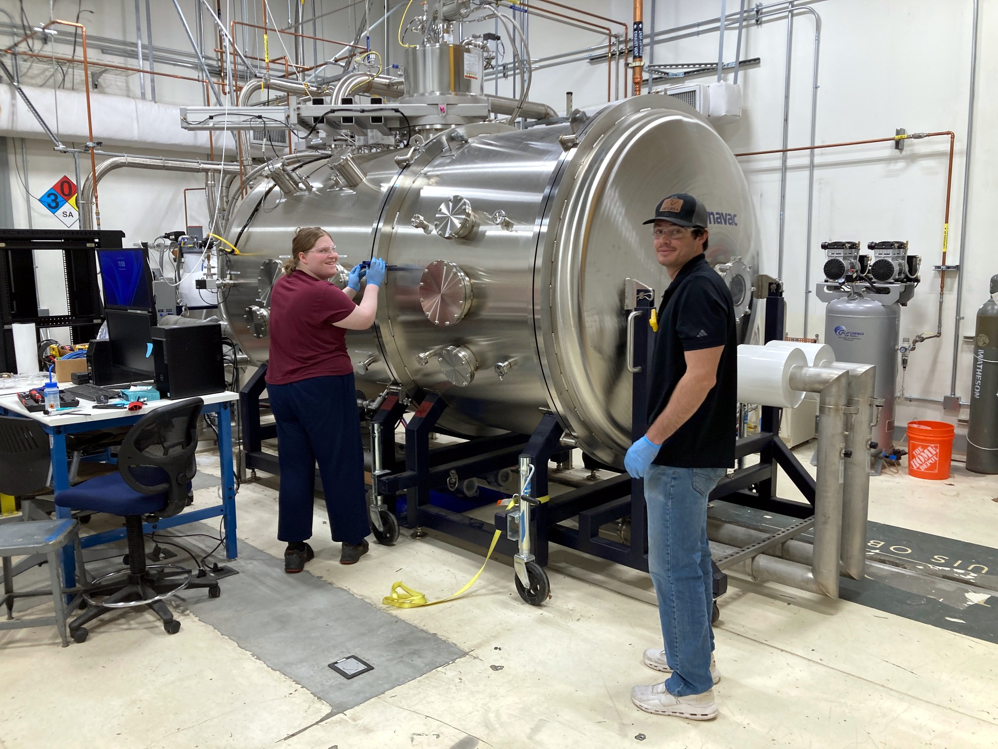 students working on cal poly large vacuum chamber stella